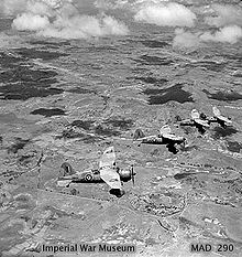 Airplane Picture - December 1942. Four Lysander Mk IIIAs of No. 1433 Flight RAF, based at Ivato, over a typical Madagascar landscape, shortly after the official end of the Madagascar campaign. (Photographer: Sgt J.D. Morris).