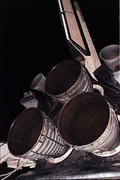 Airplane Picture - The three nozzles of the Main Engine cluster with the two Orbital Maneuvering System (OMS) pods, and the vertical stabilizer above.