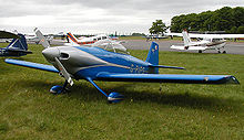 Aircraft Picture - A general aviation scene at Kemble Airfield, England. The aircraft in the foreground is a homebuilt Vans RV-4