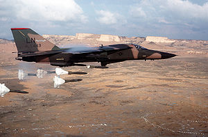 Aircraft Picture - An F-111F of the 494th Tactical Fighter Squadron releasing its load of Mark 82 high-drag bombs over the Bardenas Reales range in Navarre, Spain, in 1986