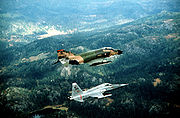 Airplane picture - New Jersey Air National Guard F-4 Phantom II aircraft flying in close formation with a Norwegian Air Force F-5A Freedom Fighter aircraft during an exercise in 1982